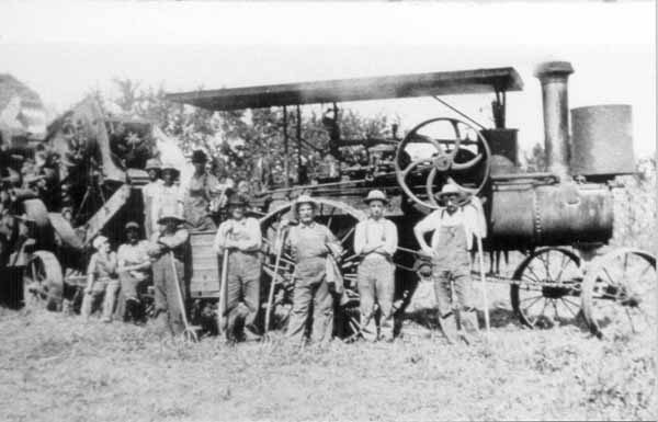 John Martin (right) by threshing machine