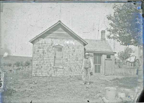 Knud Rasmussen Standing in Front of Shanty, Poplar, Iowa